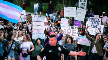 Transgender-rights protesters march in the intersection of Jefferson and Madison Streets blocking traffic at Matt Walsh event